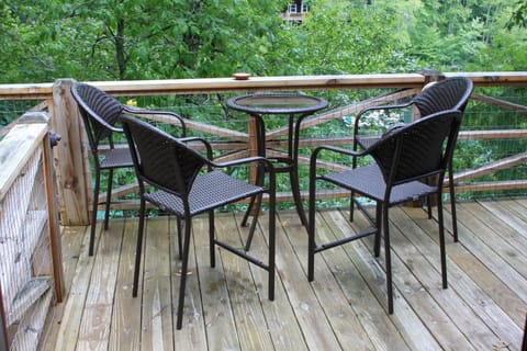 Deck chairs and table outside kitchen. View of lake from chairs.