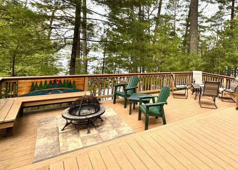 The lower level of the deck has a cozy fire pit and a table and chairs.