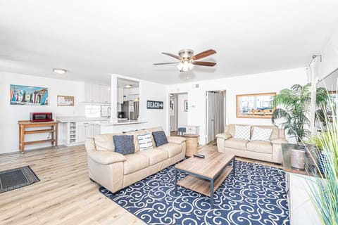 The living room area includes a sofa set and cable TV.
                