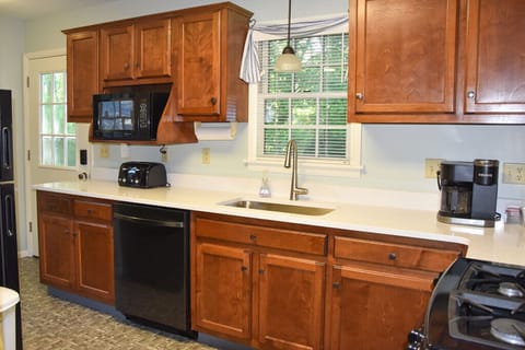 Full kitchen; quartz counters, microwave, dishwasher, and Keurig coffee maker.
