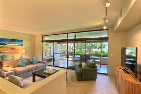 Indoor-outdoor living at its best — sliding doors open to lanai with pool view