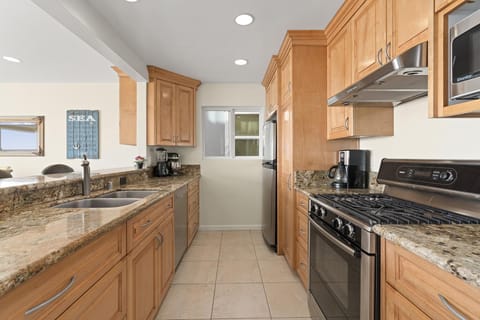 The kitchen comes stocked with dishes, utensils, cookware, bakeware, and all major and small appliances.
                