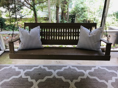 Comfy swing for relaxing on the screened porch