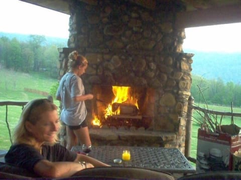 Deck fireplace under covered roof.
