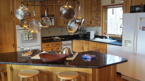 Gourmet kitchen, island gas cooktop, microwave, double oven, trash compactor.