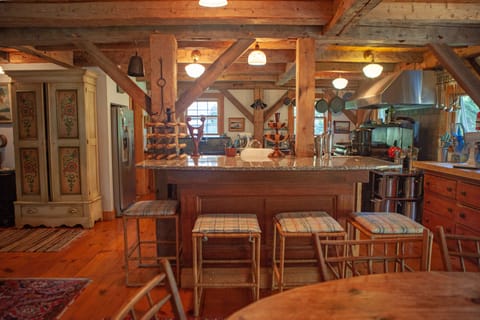 VIEW FROM DINING ROOM WITH GRANITE BAR INTO KITCHEN