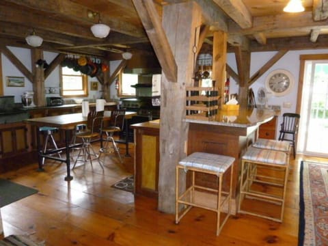 VIEW INTO KITCHEN WITH GRANITE BAR ADJOINING DINING ROOM