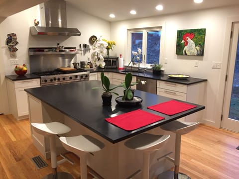 The window over the sink and French doors face the east garden and bird feeders.