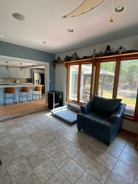 Living room flows into new kitchen for ultimate hosting w creek and lake views.