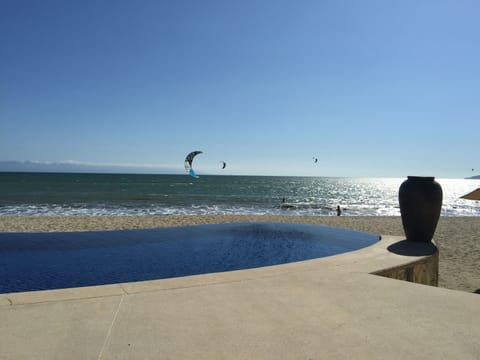 Relax and enjoy the infinity pool, beach and ocean from the private beach club.
