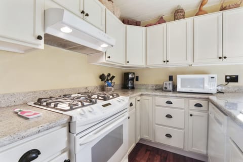 Another view of the kitchen with a gas stove. 
