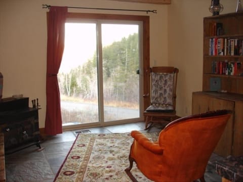 Cozy sitting room with library & rockers and relaxing mountain views