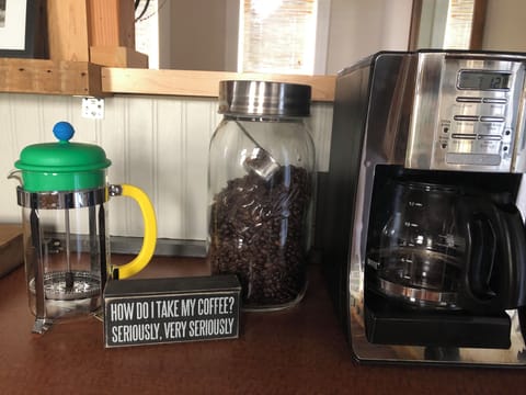 French press, coffee beans, grinder and coffee pot