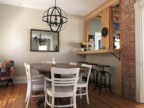 Large dining table and breakfast bar open to the kitchen