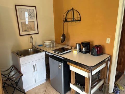 Mini kitchen with hot plate, refrigerator, toaster, oven, tea, kettle, microwave