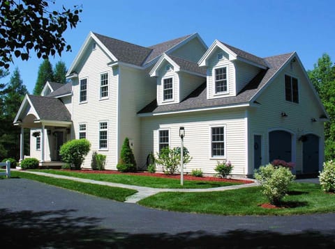 View of the front of the house with ample parking, including heated 2-car garage