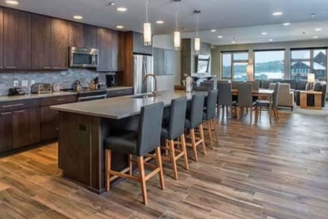 Huge chef`s kitchen with bar seating as well as a large dining table