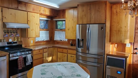 Brand new gas range, hood, refrigerator, dishwasher, microwave, and sink.