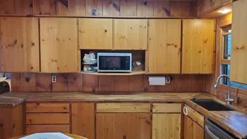 Plenty of cabinet space, fully stocked with dishes, pots, pans, and utensils