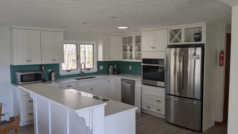 Kitchen close-up, fully equipped with stove, oven, microwave, toaster, etc.