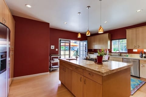 Kitchen with stainless steel appliances, center island, coffee maker, blender, recessed lighting, toaster, blender, and a gas stove