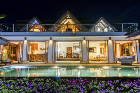 Villa and pool at night
