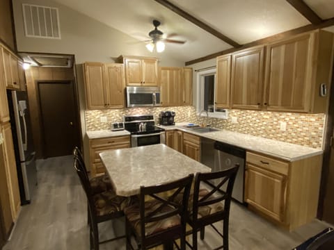 Fully stocked kitchen with double oven range, microwave, dishwasher & fridge