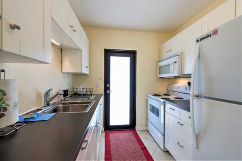 Fully equiped kitchen has full size fridge, range and built-in microwave.