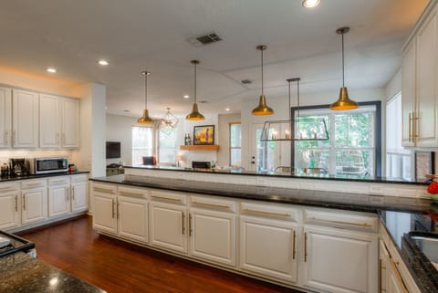 Spacious kitchen with all the appliances and some condiments for use.
