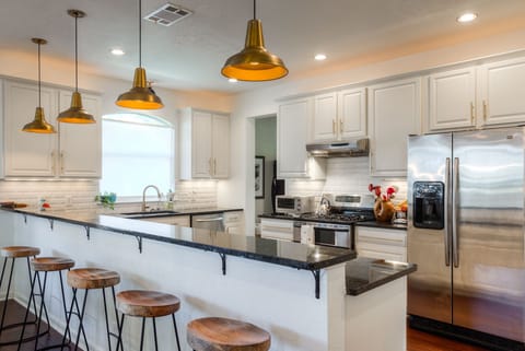 Bar looking into kitchen with 5 stools.