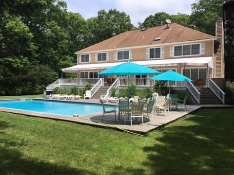 Back yard with heated pool, awing on upper deck, 
lounge chairs with cushions