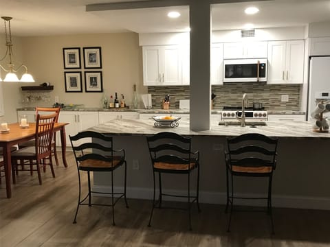 Seating on the kitchen island and new bar area in the dining room