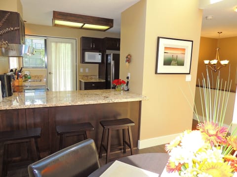 Open kitchen with granite bar top.