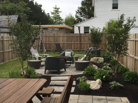 Backyard patio with dining table and lounge chairs
