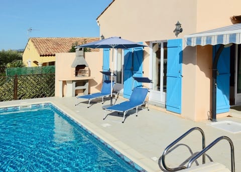 Sunny front of villa with barbecue