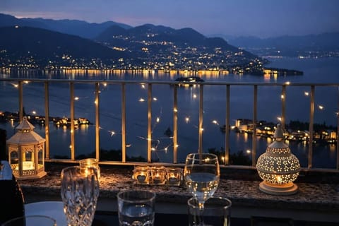 As twilight deepens, candlelight flickers while the shoreline glows below. Settle in with good company, gentle breezes, and sweeping vistas—where conversations linger late and the world feels deliciously distant.