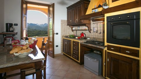 Well equipped kitchen with patio doors to terrace