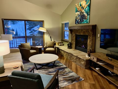 A warm and inviting living room with spacious vaulted ceiling.