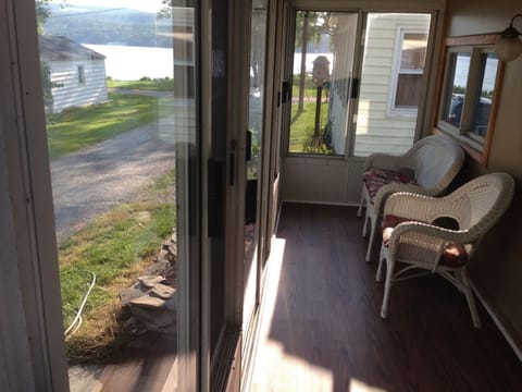 Enclosed Porch Showing View of Lake at End of Street