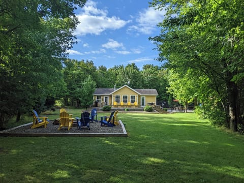 Exterior view of cottage with a beautiful firepit