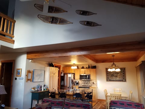 Open plan kitchen & dining area. Full view of the back yard from the glass doors
