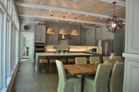 Open kitchen and dining room. Table seats 10, and counter seats 6 