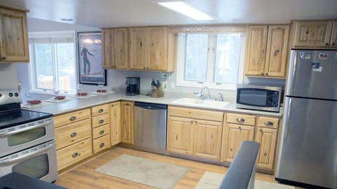Open and spacious kitchen with hickory cabinets and updated stainless appliances