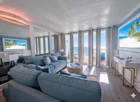 Sunlit living room with panoramic ocean views and cozy seating