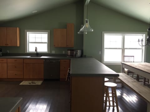 Kitchen with new GE appliances. Wall oven, flat top stove, dishwasher. 