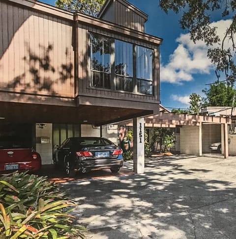 Two car carport surrounded by shady southern oaks.
