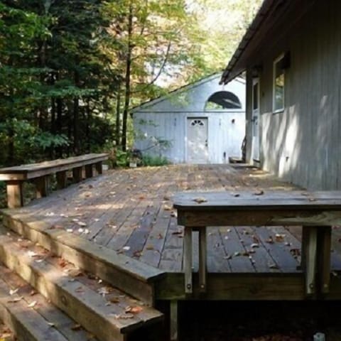 Large rear deck and outside seating area. Tables, chairs, and grill provided.