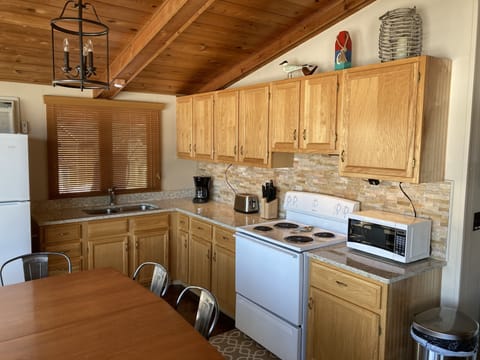Updated kitchen w/ AC, fridge, range/oven, microwave, coffee maker and toaster.