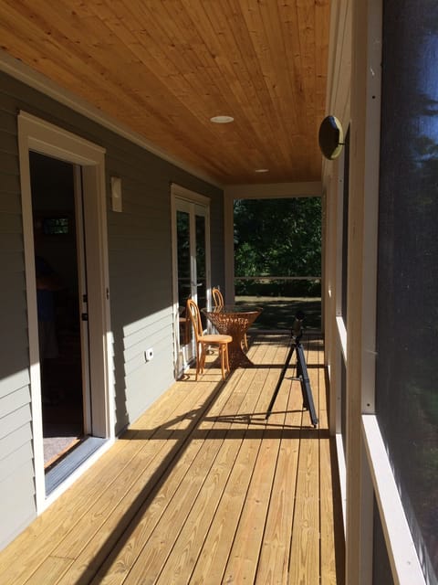 Front porch is screened so doors can be left open to expand the living space.