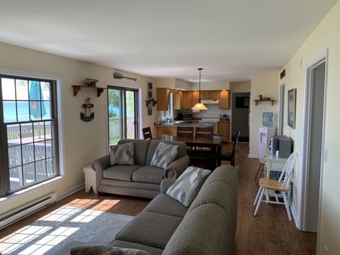 View of living room, dining area, and kitchen all overlooking the lake 
